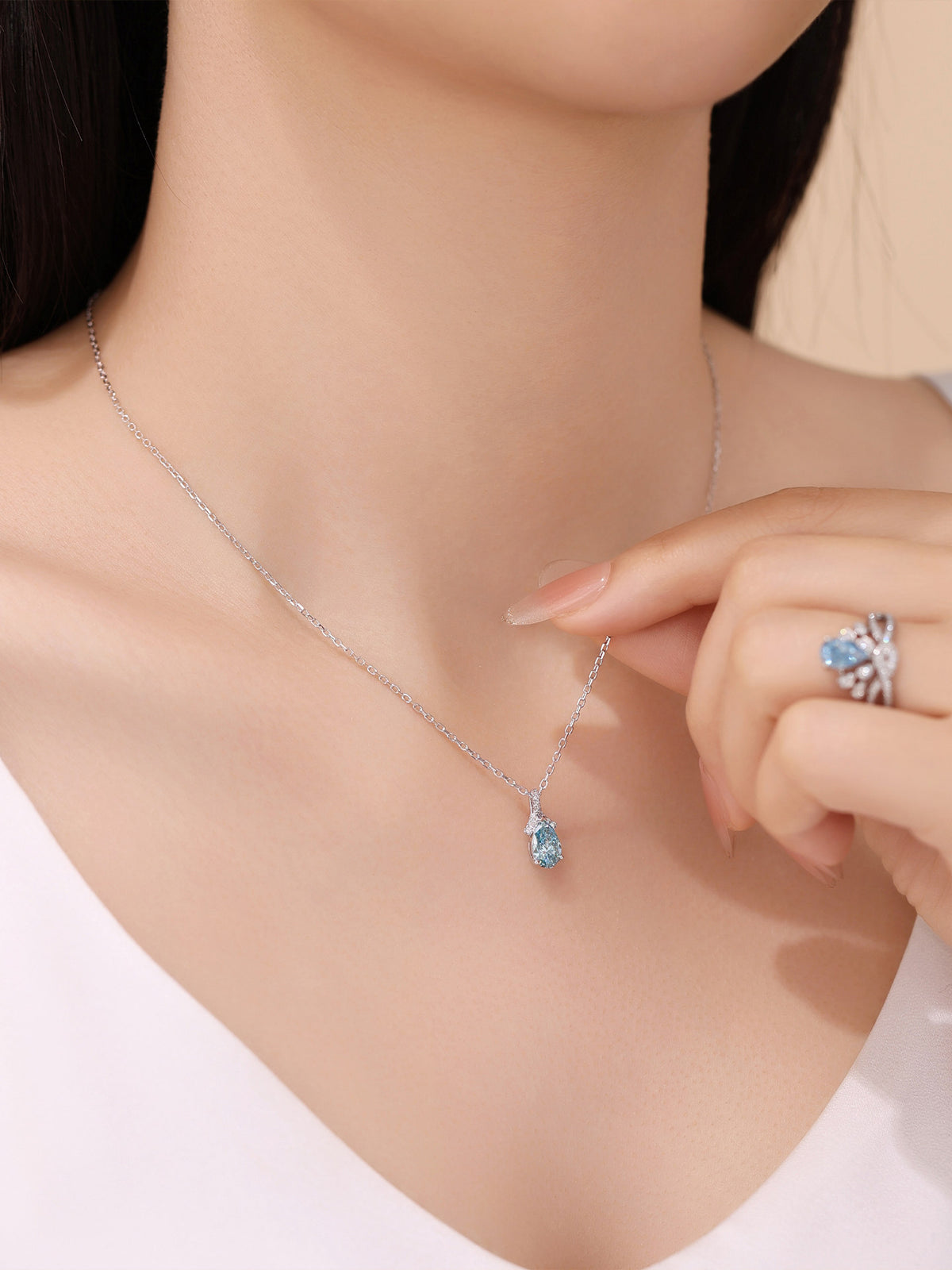 DANFÉE Ribbon Bow Pear 1 carat blue diamond necklace on model, close-up