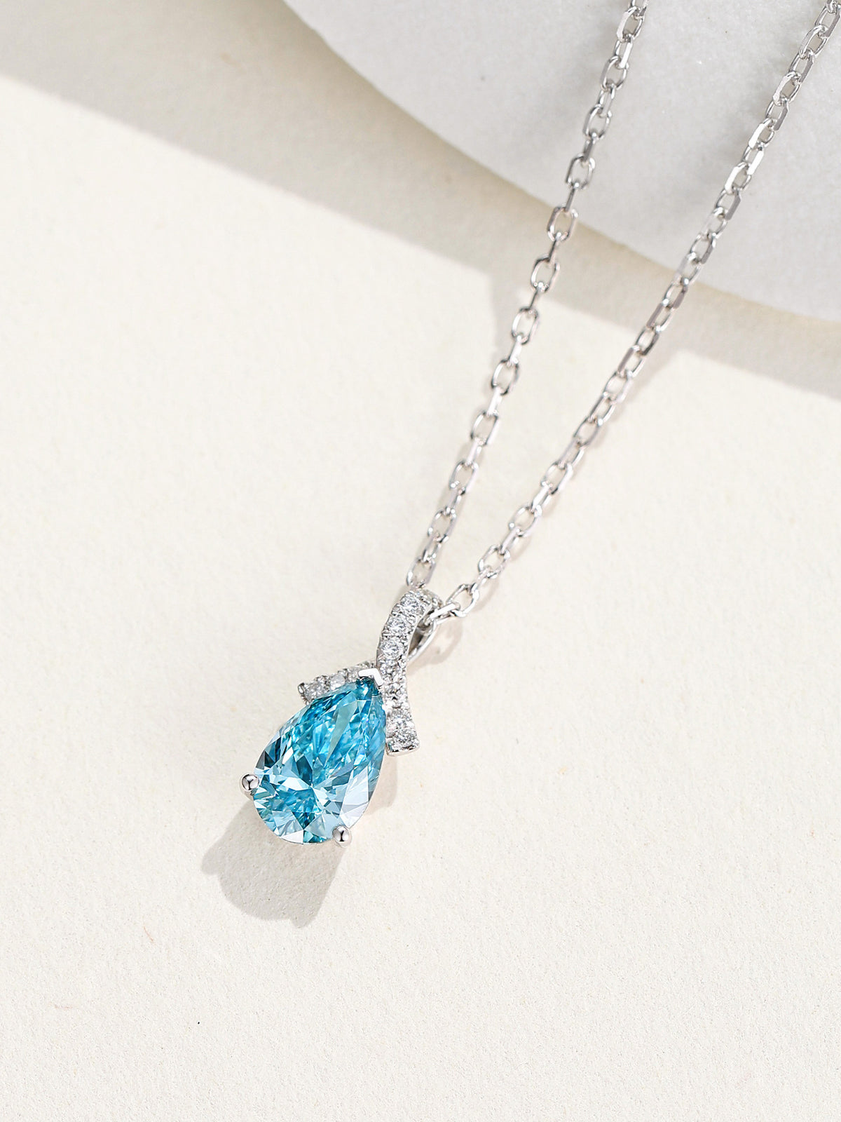 DANFÉE Ribbon Bow Pear blue diamond pendant on ivory stone