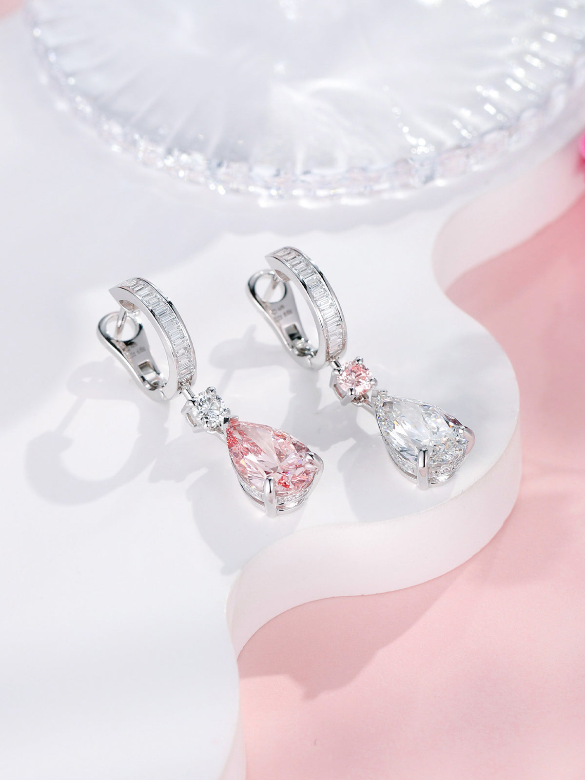 Rosée toi et moi pear diamond earrings, pink and white, on a white and pink display