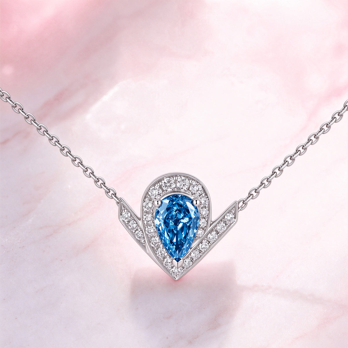 DANFÉE Chevron Pear Halo blue diamond necklace on pink marble