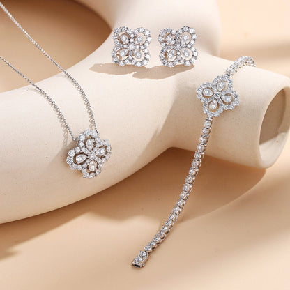 Clover halo lab-grown diamond necklace styled with matching earrings and bracelet
