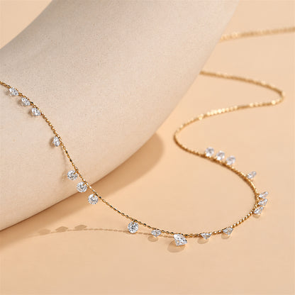 DANFÉE Muse lab-grown diamond station necklace — 18K yellow gold on warm beige stone display