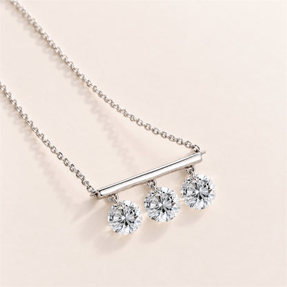 DANFÉE Three-stone lab-grown diamond bar necklace on a warm ivory background