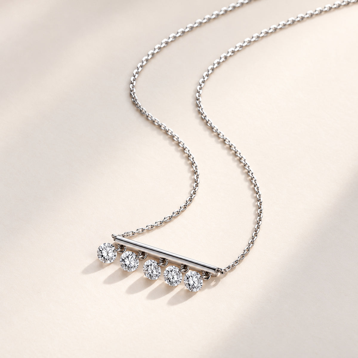 DANFÉE Five-diamond bar necklace on an ivory surface