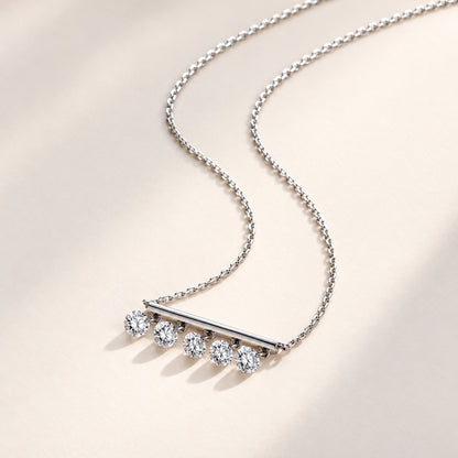 DANFÉE Five-diamond bar necklace on an ivory surface