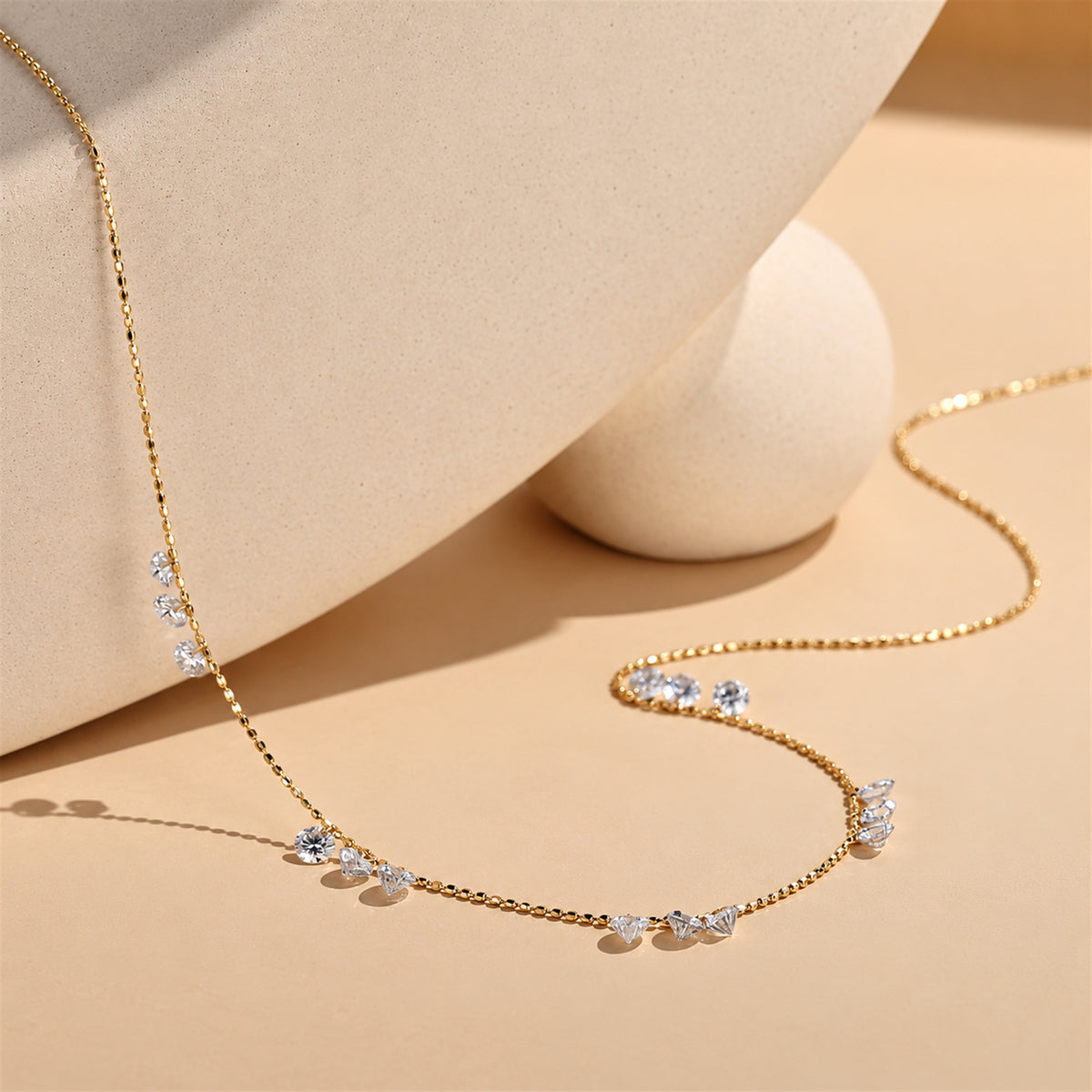 DANFÉE diamond necklace draped in a warm beige setting