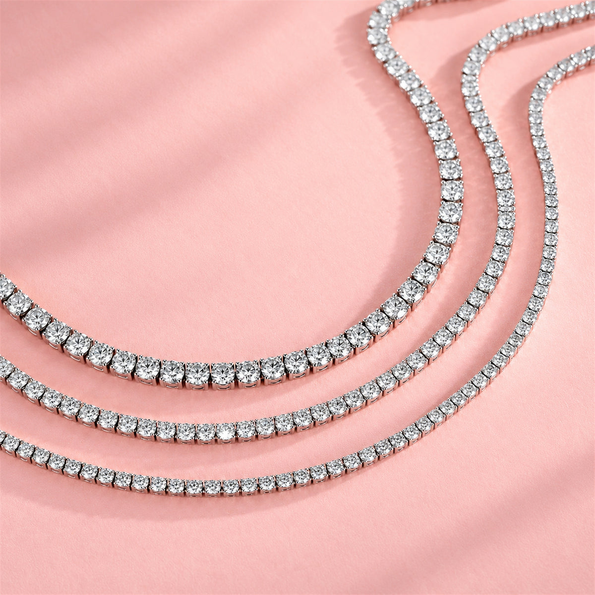 DANFÉE diamond tennis necklace — three necklace sizes on pink background