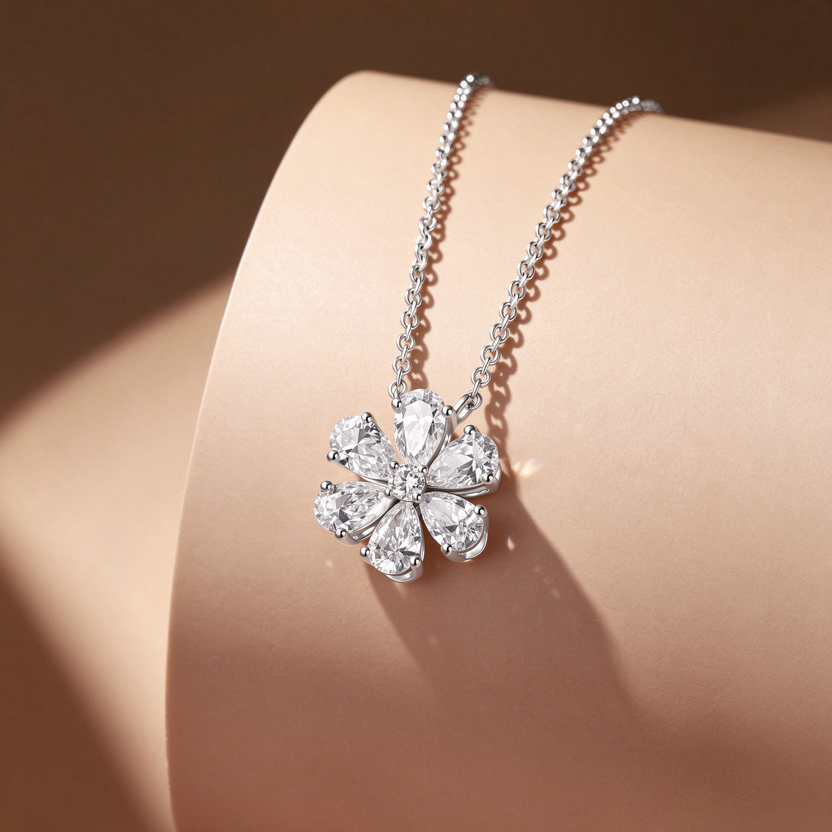 DANFÉE Forget-Me-Not lab-grown diamond flower necklace in PT950 platinum displayed on a warm-toned stand