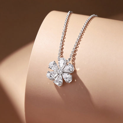 DANFÉE Forget-Me-Not lab-grown diamond flower necklace in PT950 platinum displayed on a warm-toned stand