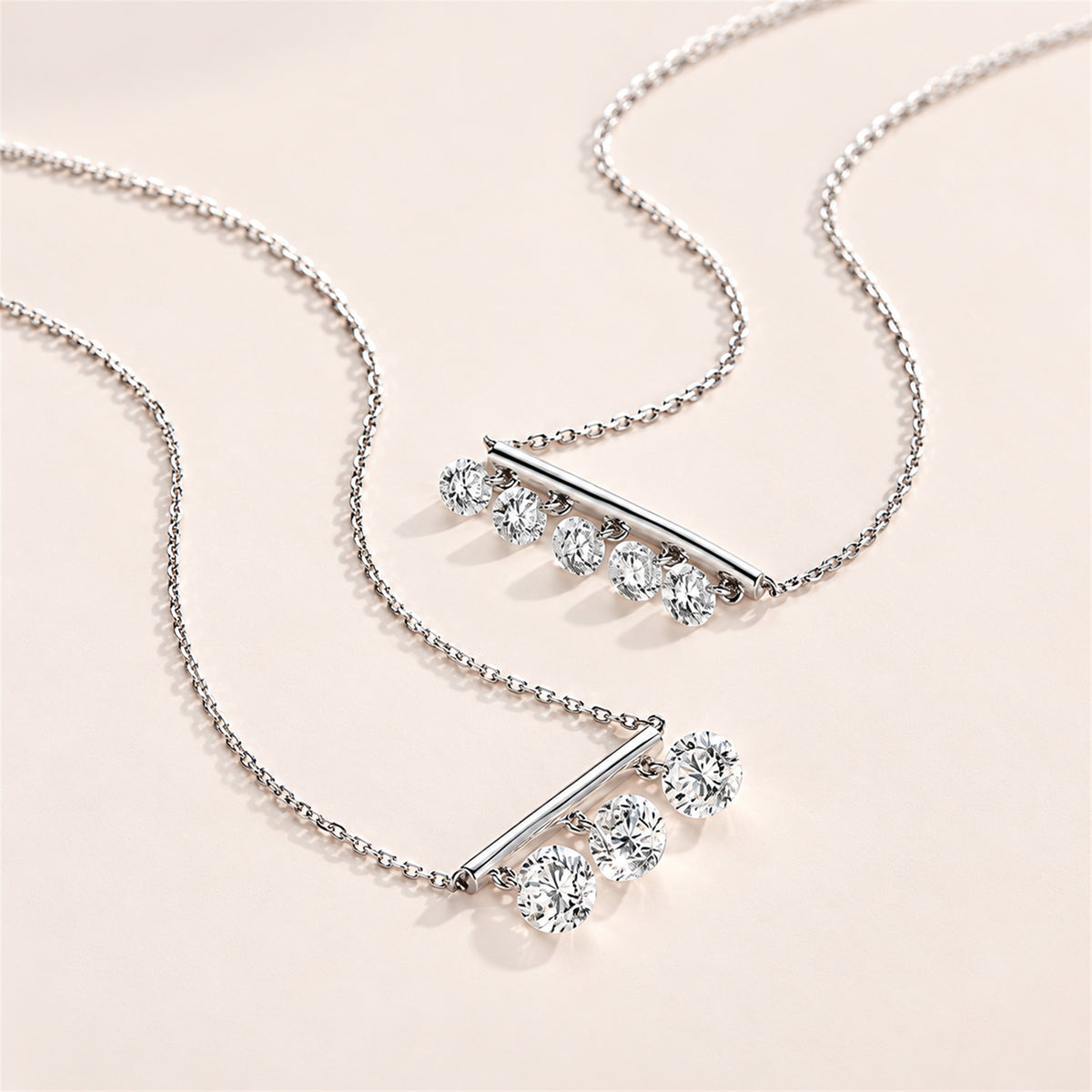 DANFÉE Design comparison of three-stone and five-stone diamond bar necklaces; this listing is the three-stone design
