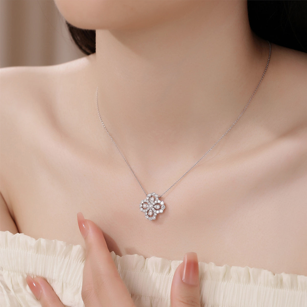 Model wearing the clover halo lab-grown diamond pendant necklace at the collarbone