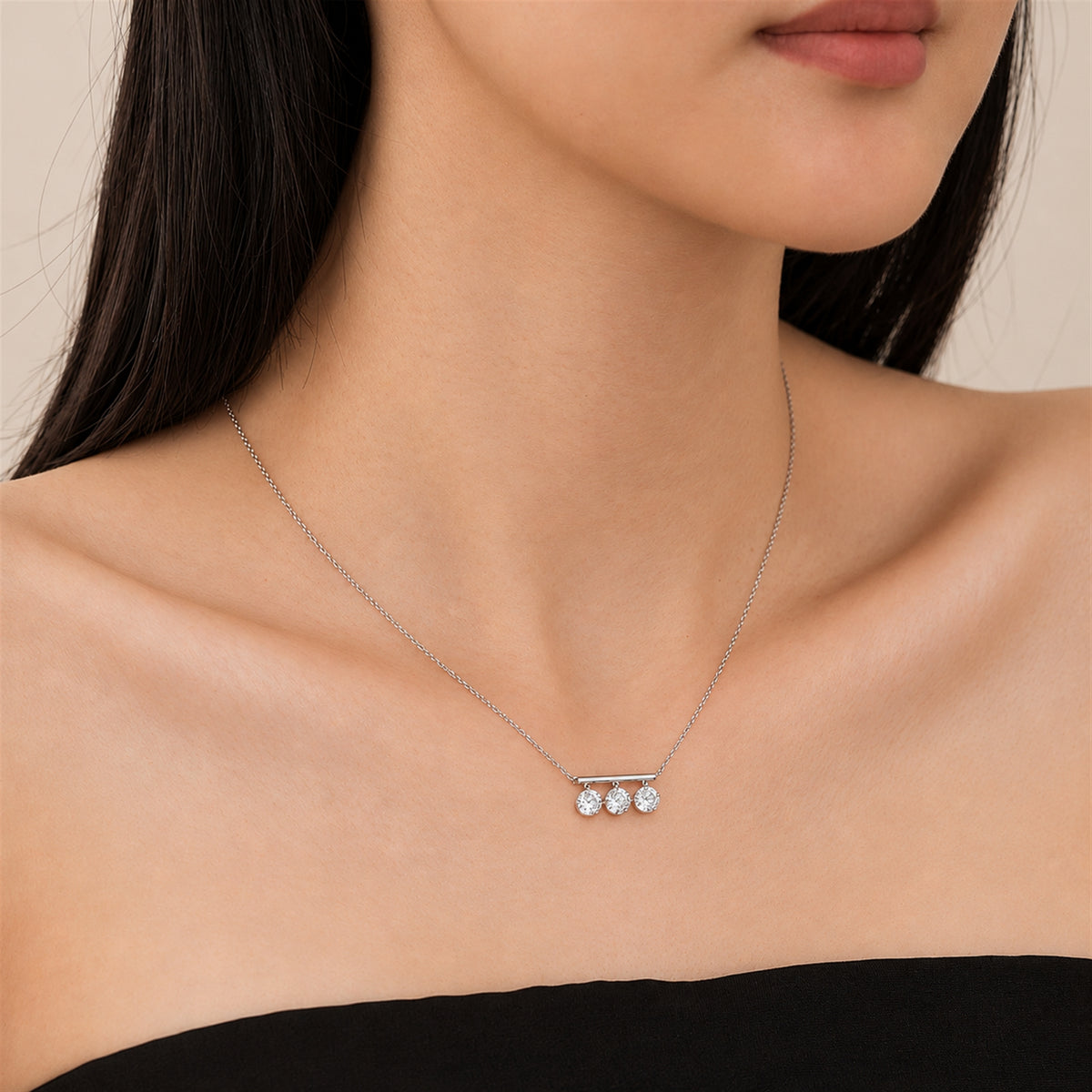 DANFÉE Three-stone lab-grown diamond bar necklace worn with a black neckline