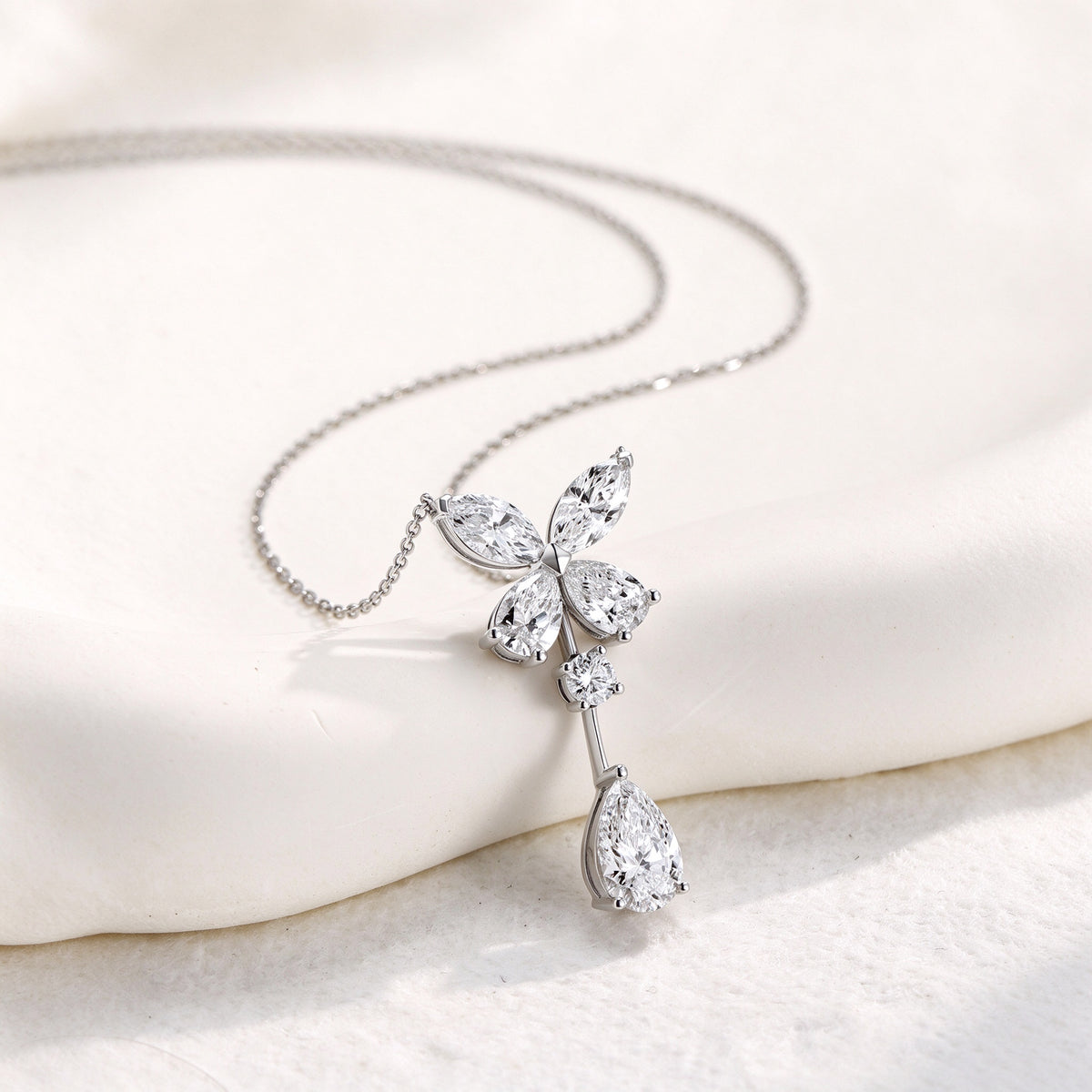 DANFÉE butterfly pear drop lab-grown diamond necklace, styled on ivory