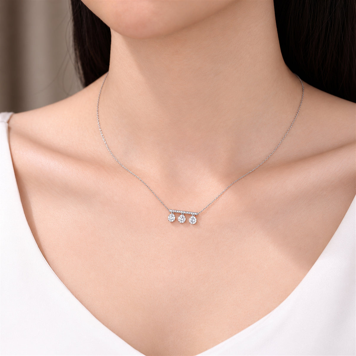 DANFÉE Three-stone lab-grown diamond bar necklace worn with a white neckline