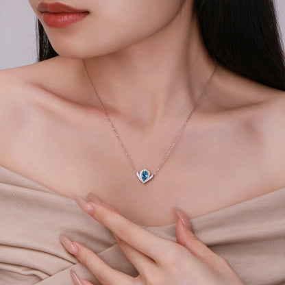 Model wearing the DANFÉE Chevron Pear Halo blue diamond necklace