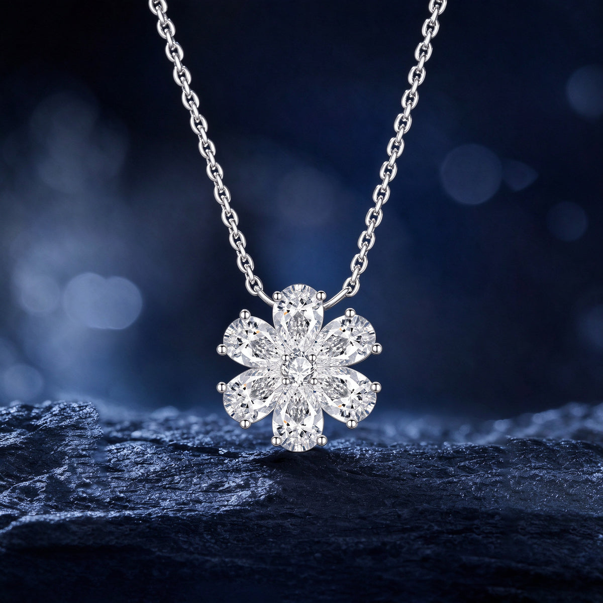 DANFÉE Forget-Me-Not pear-cut lab-grown diamond flower pendant against a midnight blue backdrop