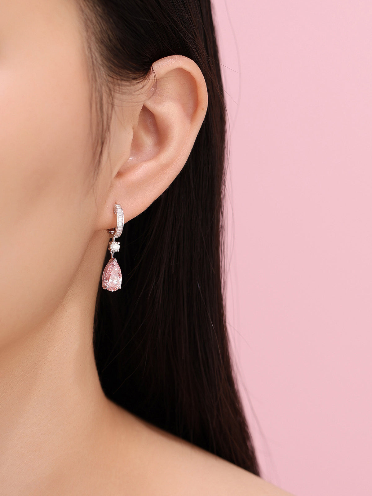 Model wearing the Fancy Vivid Pink pear diamond earring