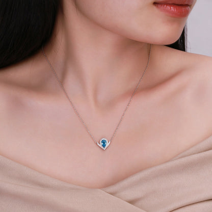 DANFÉE Chevron Pear Halo blue diamond necklace worn at the collarbone