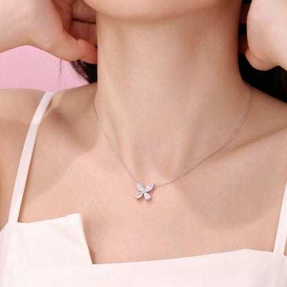 DANFÉE Four-Leaf Clover lab-grown diamond necklace worn by model, white camisole hand detail