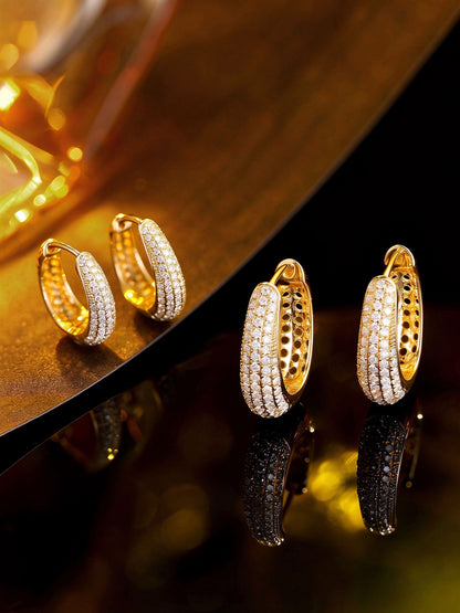 Two sizes of lab-grown diamond huggie hoops in 18K gold