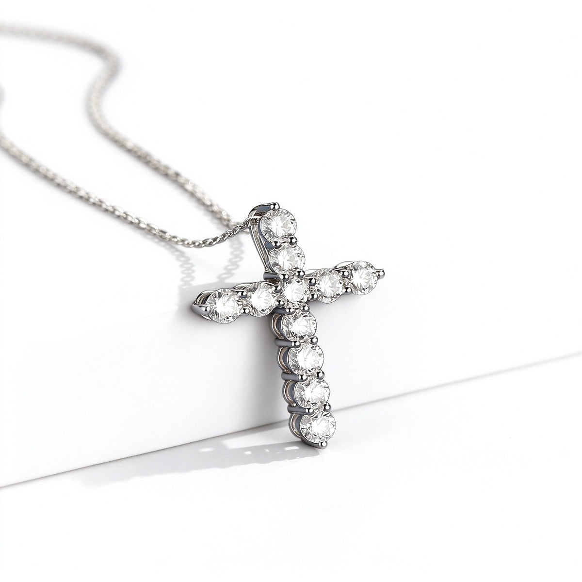 Platinum lab-grown diamond cross pendant, side view showing claw prongs