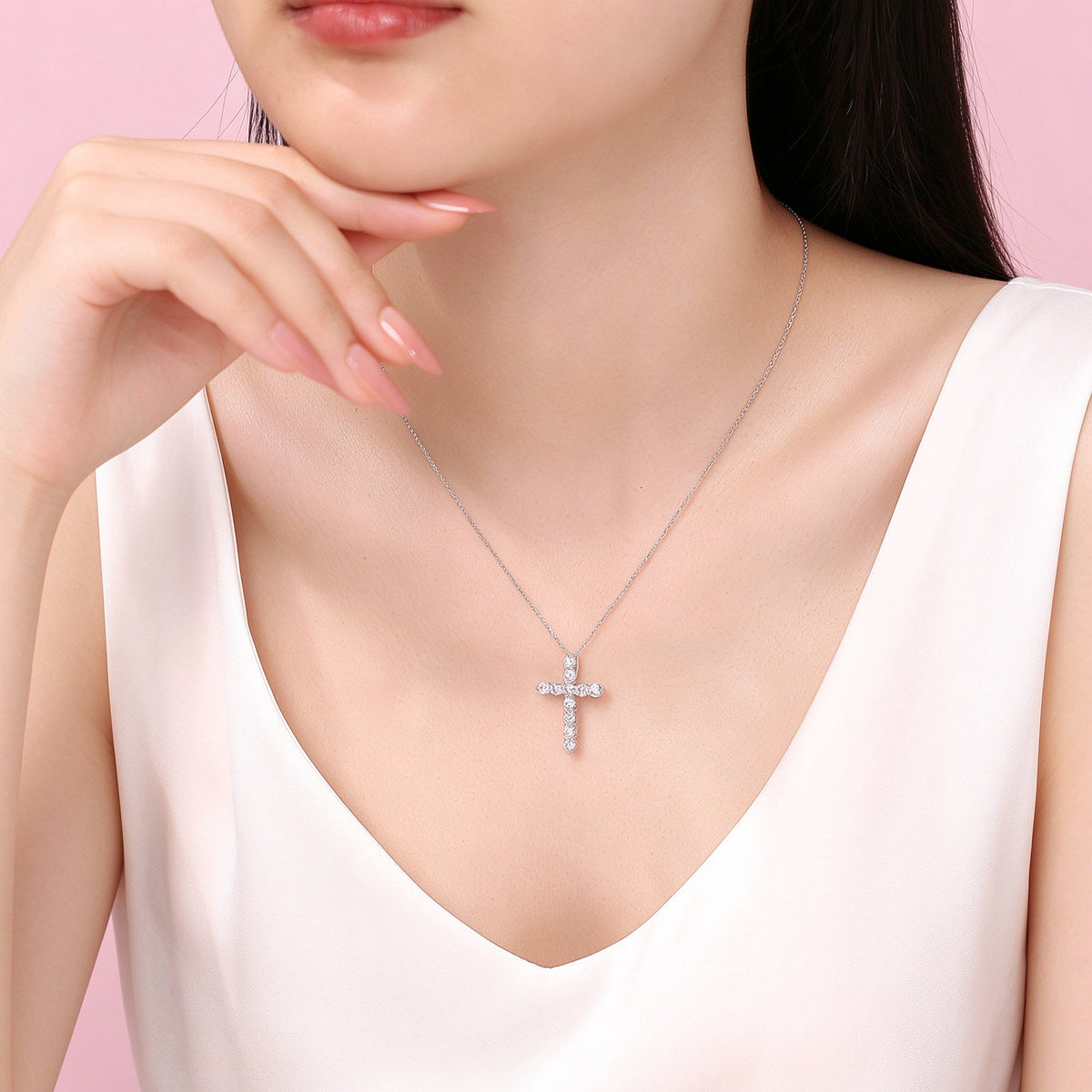 Platinum diamond cross necklace worn with a V-neck top