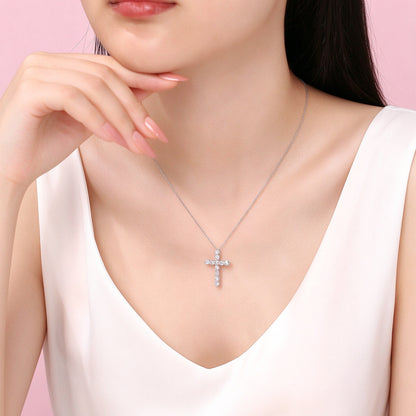 Platinum diamond cross necklace worn with a V-neck top