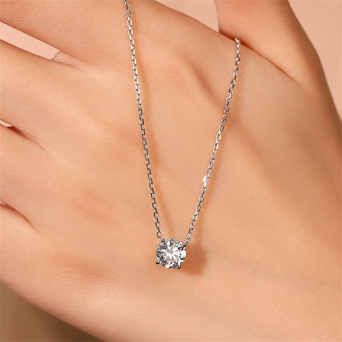 Silver-colour diamond necklace detail held in a hand