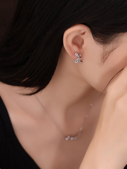 Platinum diamond knot earring on the ear, side profile