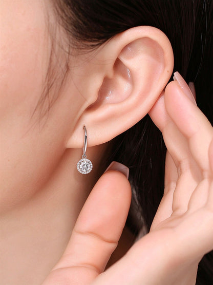 Model wearing the round halo lab-grown diamond drop earring on a French hook