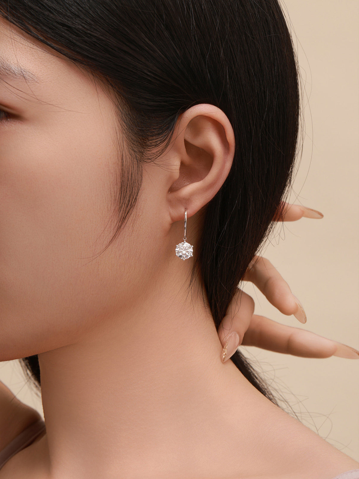 Close-up of Aurore 18K gold diamond drop earring on model