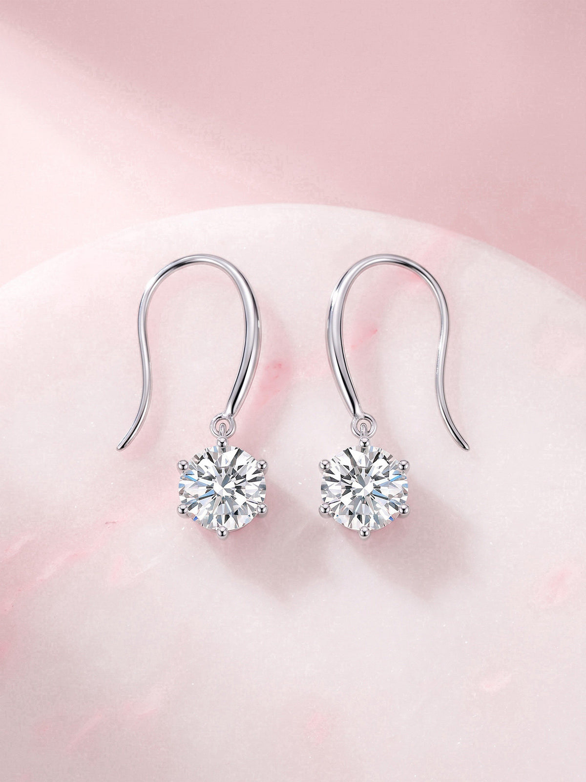 Aurore round solitaire diamond drop earrings on pink marble