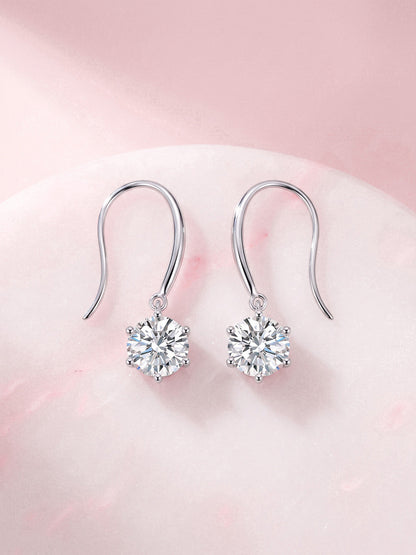 Aurore round solitaire diamond drop earrings on pink marble