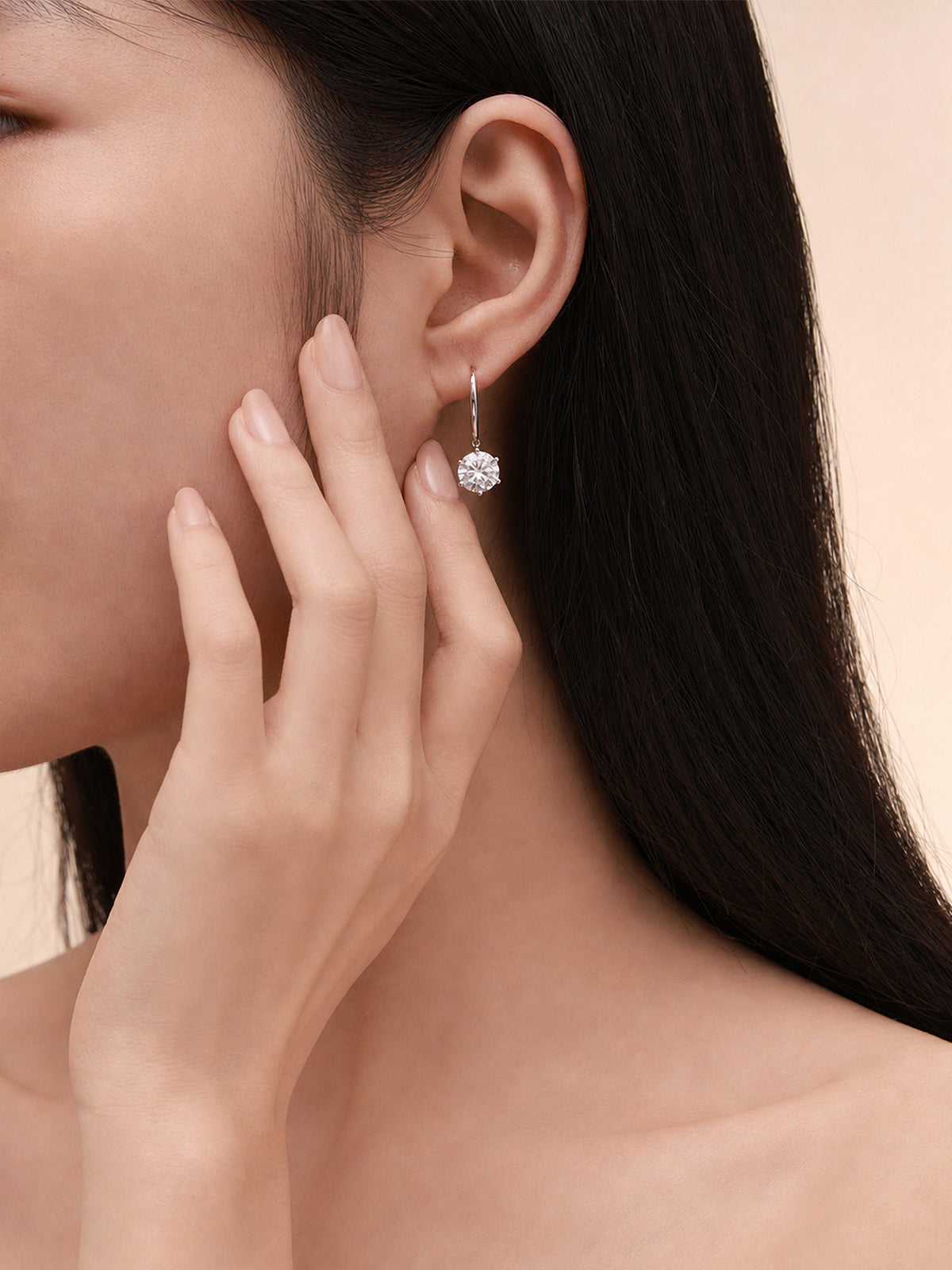 Aurore solitaire diamond drop earring worn on the ear