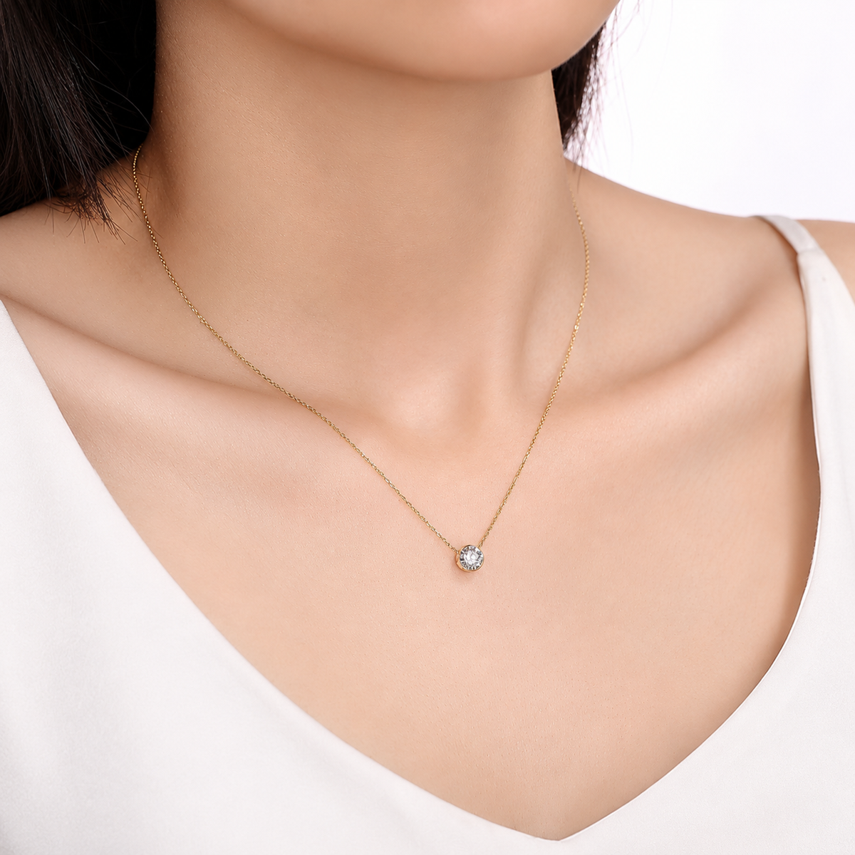 DANFÉE bezel-set diamond necklace worn with a white top