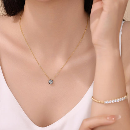 DANFÉE 1 carat lab-grown diamond necklace in 18K yellow gold worn with a white top, hand beside face