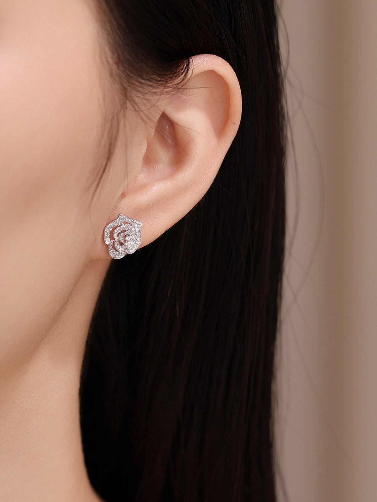 Camellia lab-grown diamond stud earring worn on the ear