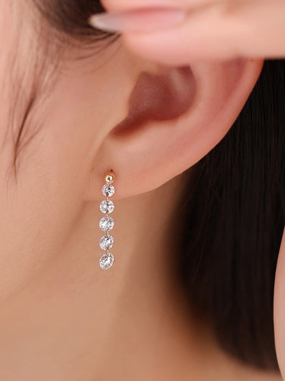Close-up of graduated diamond drop earring on the ear