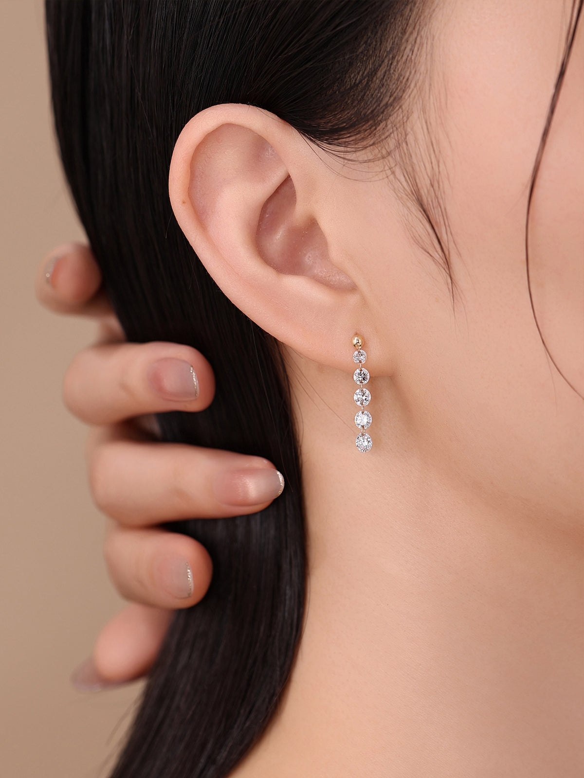 Model wearing DANFÉE Cascade diamond drop earring