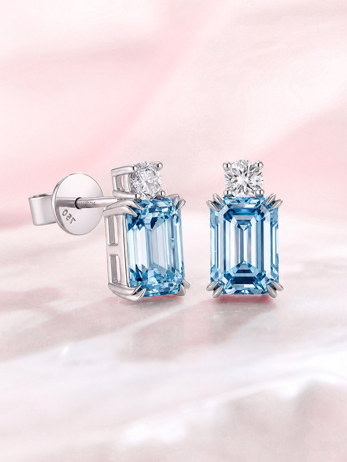 Side view of blue emerald-cut diamond stud earrings in 18K white gold claw setting