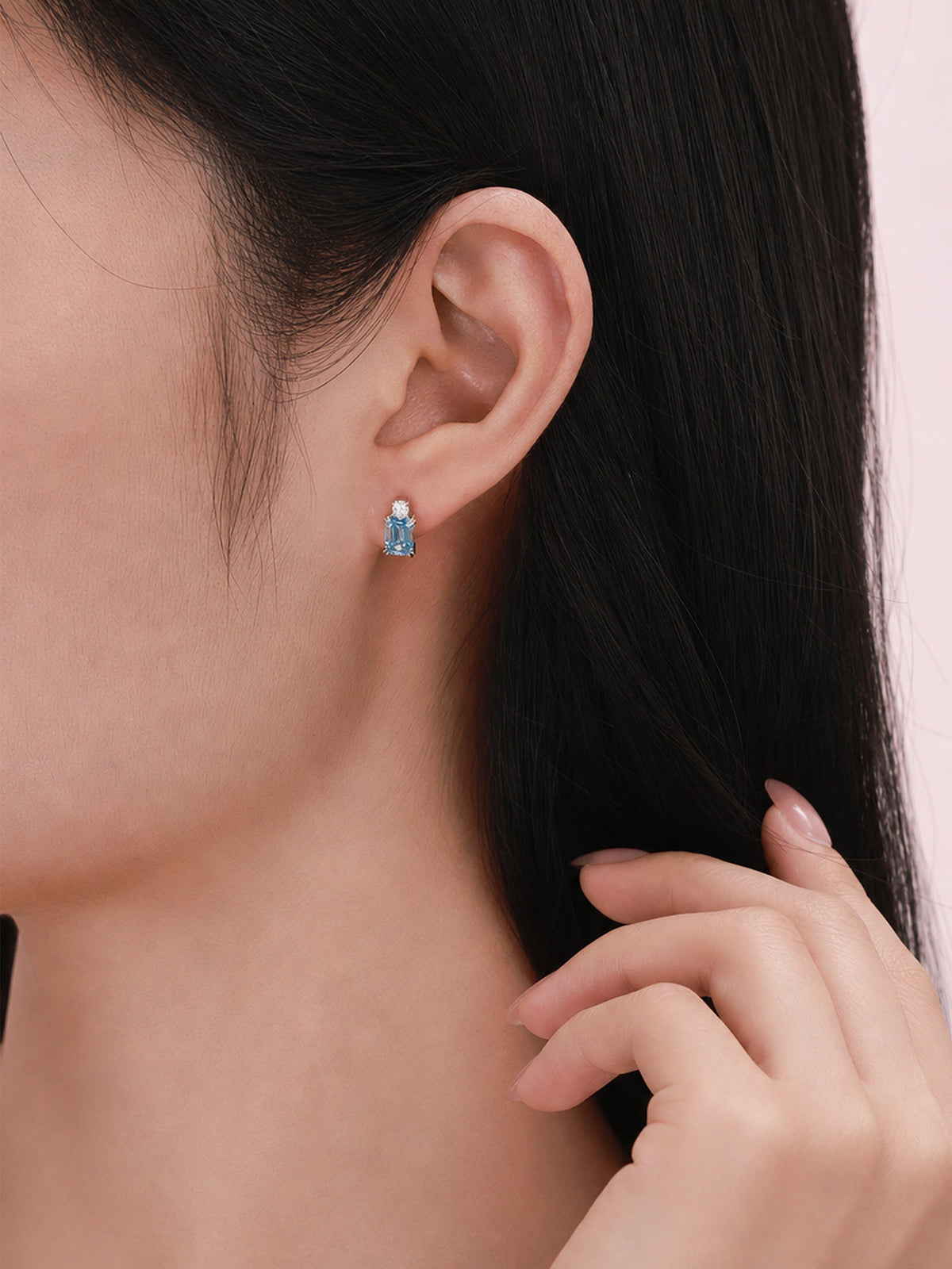 Blue diamond stud earring on the ear, 18K white gold