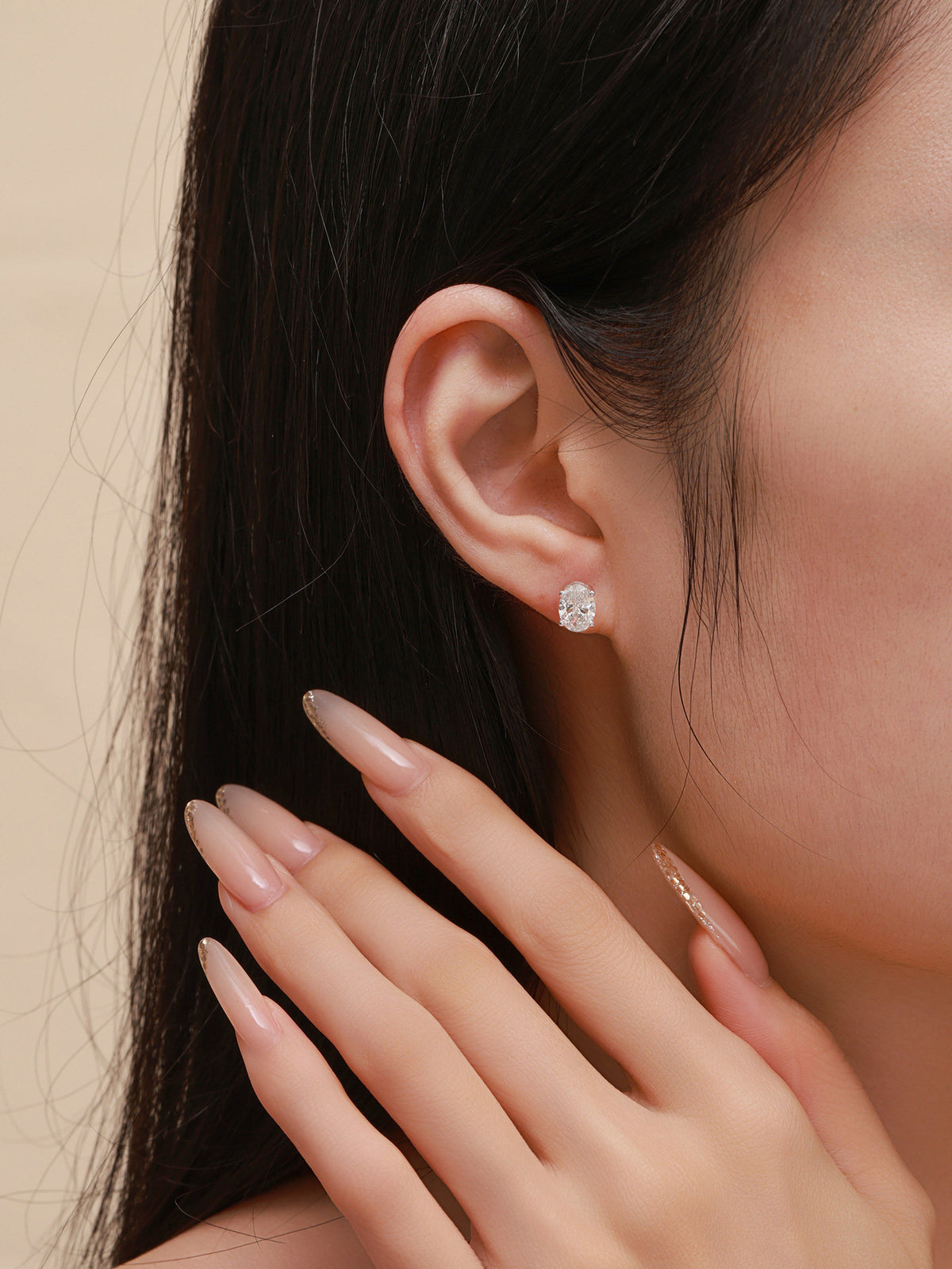 Céleste oval lab-grown diamond stud earring on the ear, close-up