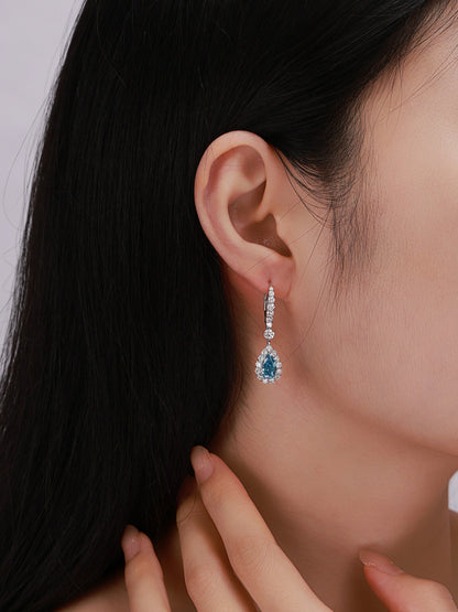 On-ear view of fancy vivid blue lab-grown diamond halo drop earring with lever-back
