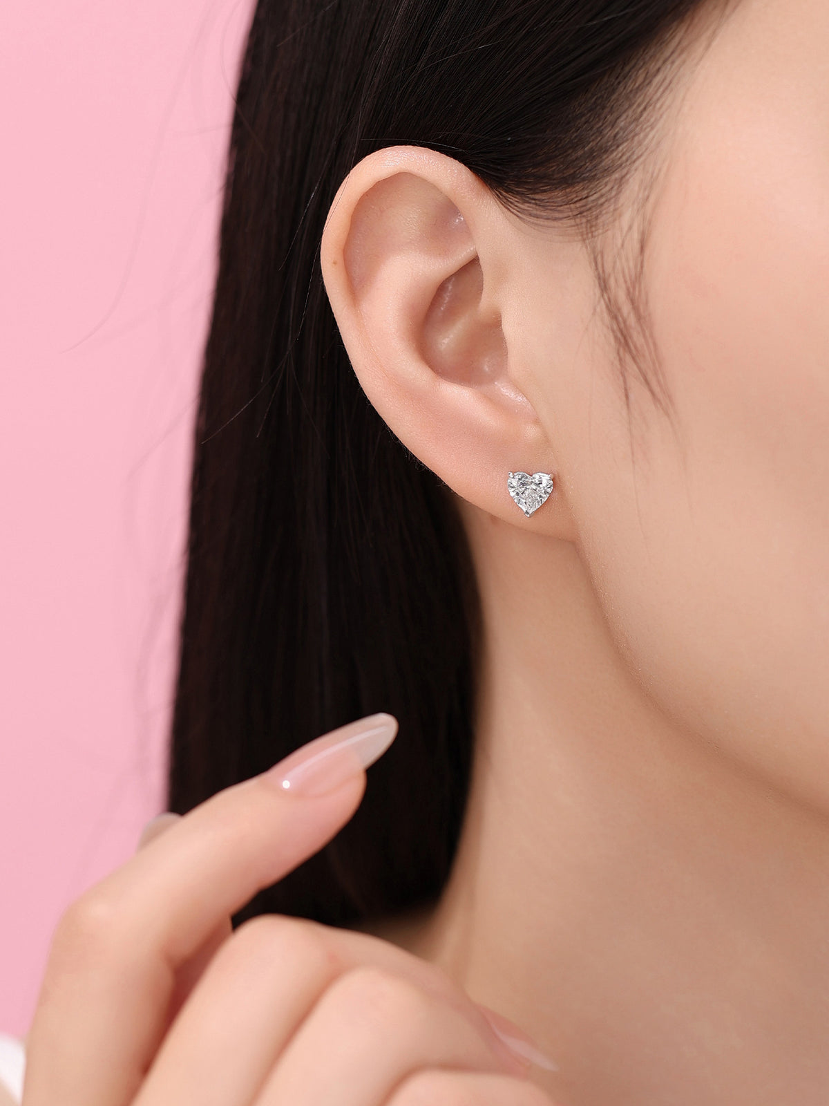 Heart-cut lab-grown diamond stud earring worn on the ear