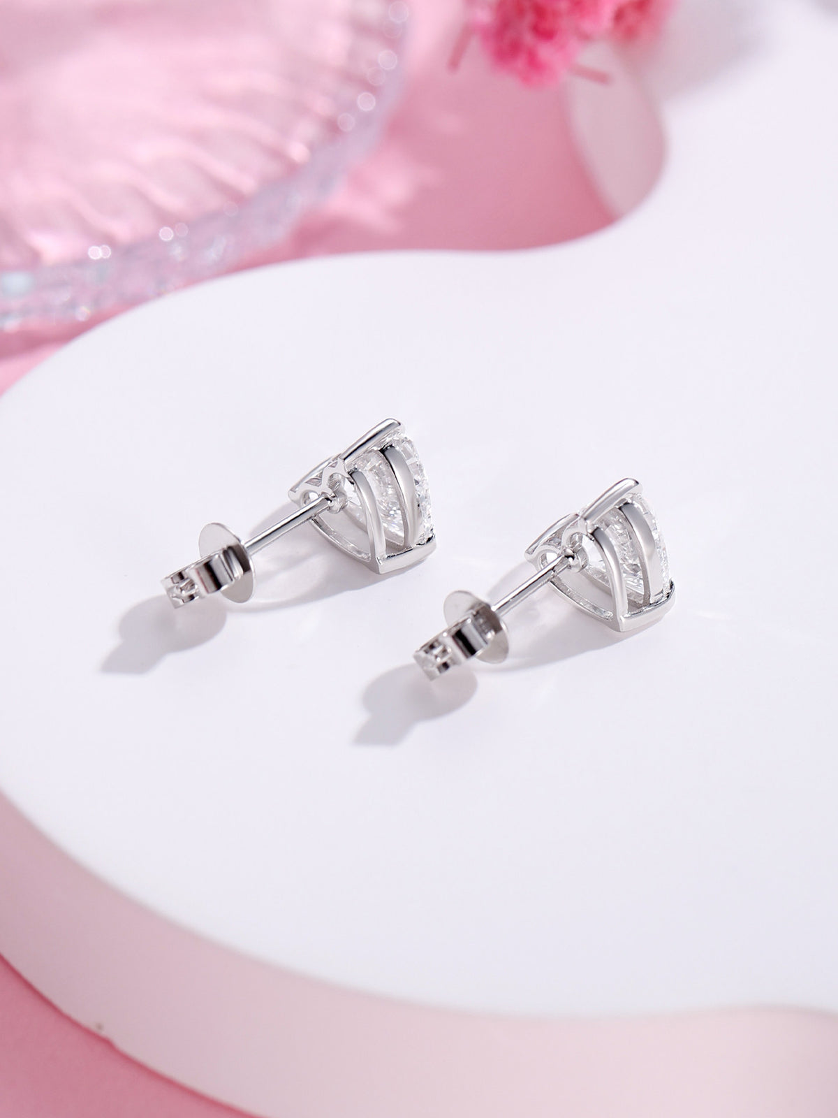 Side view of heart diamond stud earrings showing open basket and butterfly push back