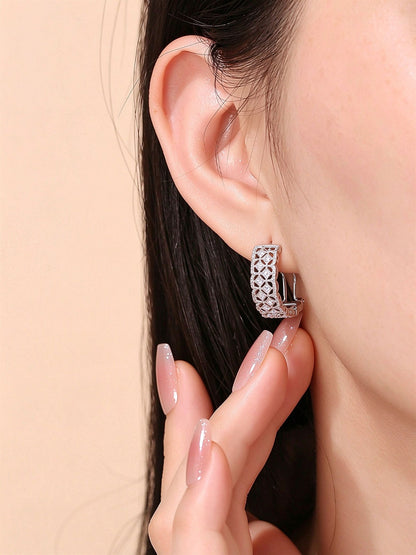 Model wearing Dentelle PT950 platinum diamond huggie earring
