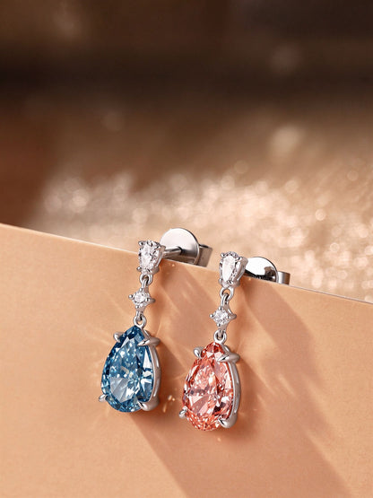 DANFÉE Duet blue and pink lab-grown diamond drop earrings displayed on a warm-toned ledge