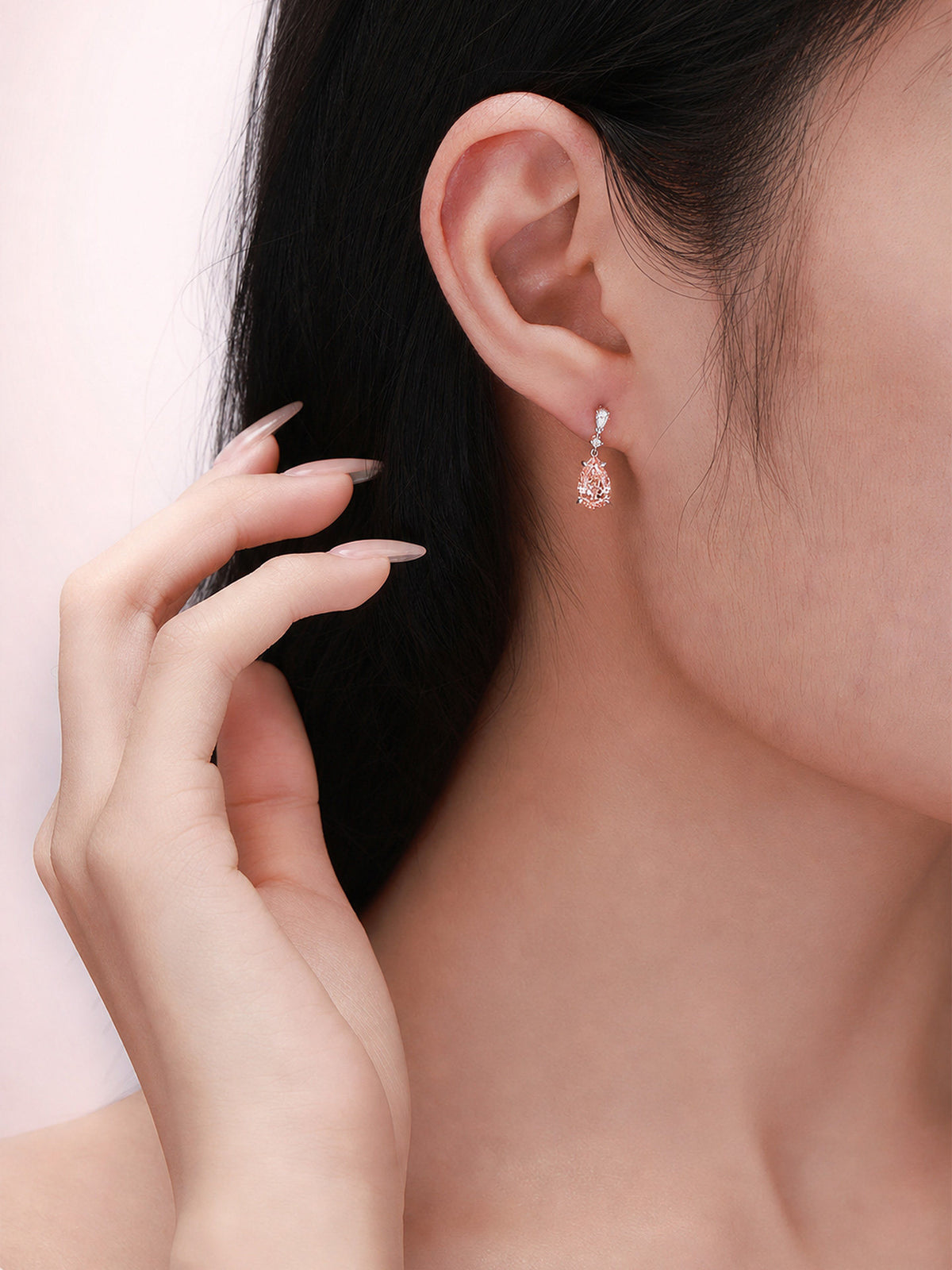 Fancy Vivid Pink pear-cut lab-grown diamond drop earring worn on the ear