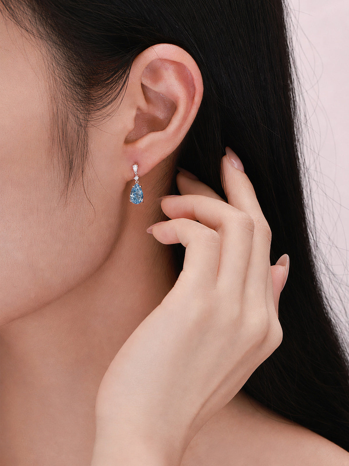 Fancy Vivid Blue pear-cut lab-grown diamond drop earring worn on the ear