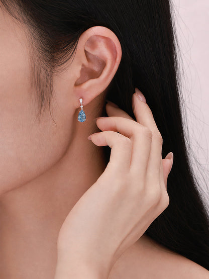 Fancy Vivid Blue pear-cut lab-grown diamond drop earring worn on the ear